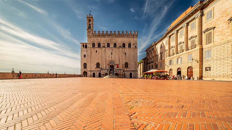 tour guests outside Palazzo dei Consoli, Gubbio, Italy